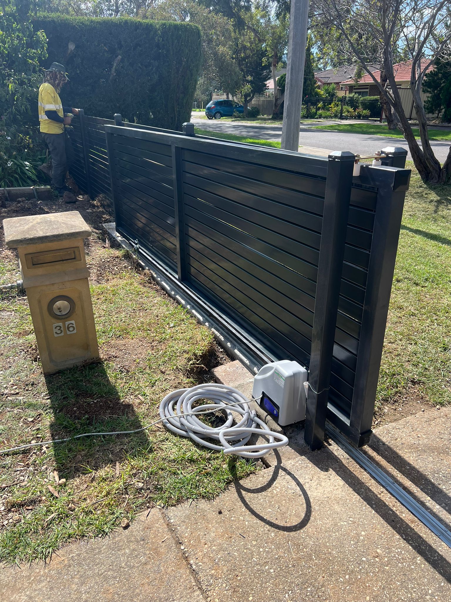 Re-hung aluminium sliding gate on its track, Mill Park